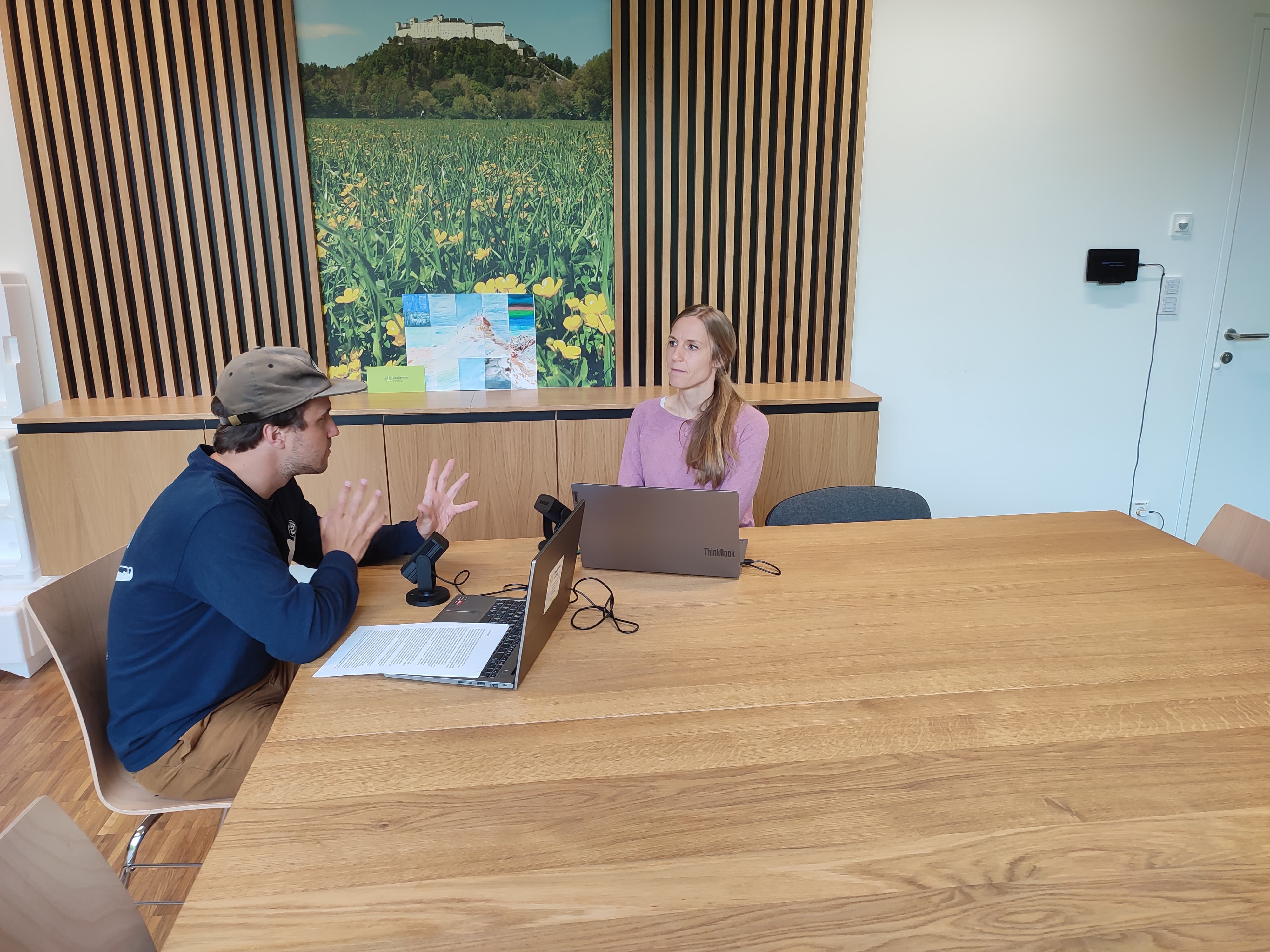 Two people are sitting at a table.